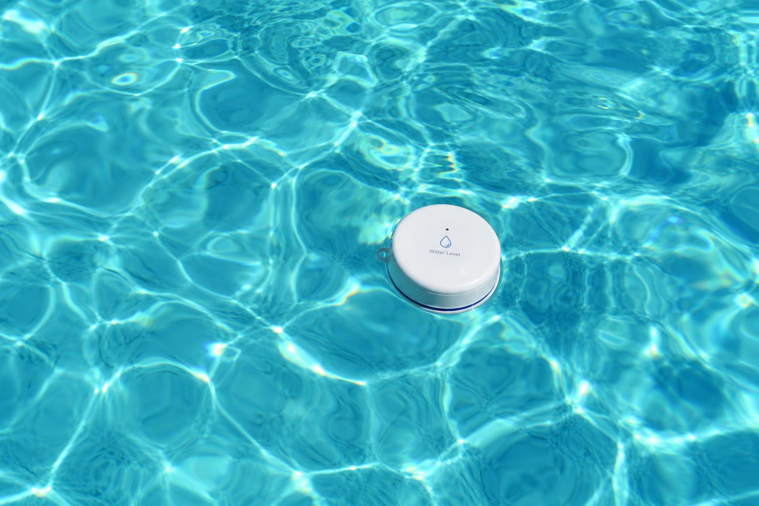 Close-up of clear swimming pool water with a floating water quality sensor